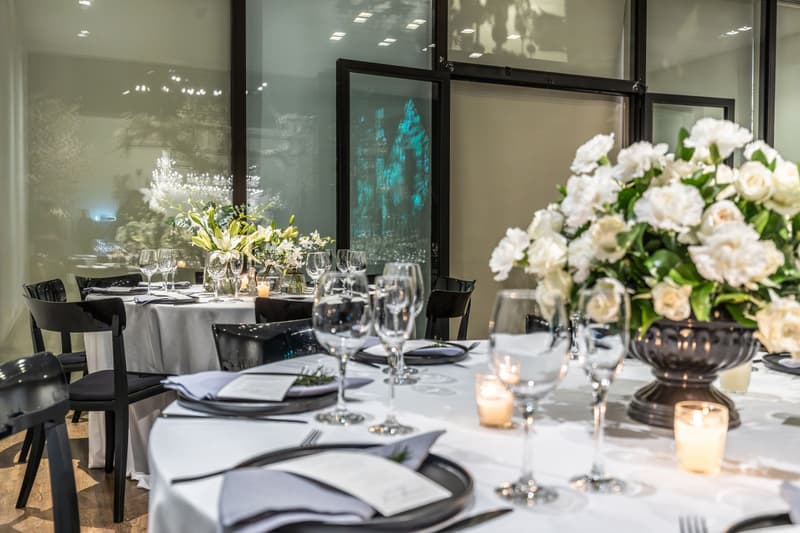 Banquet tables set with white flowers, candles and glassware